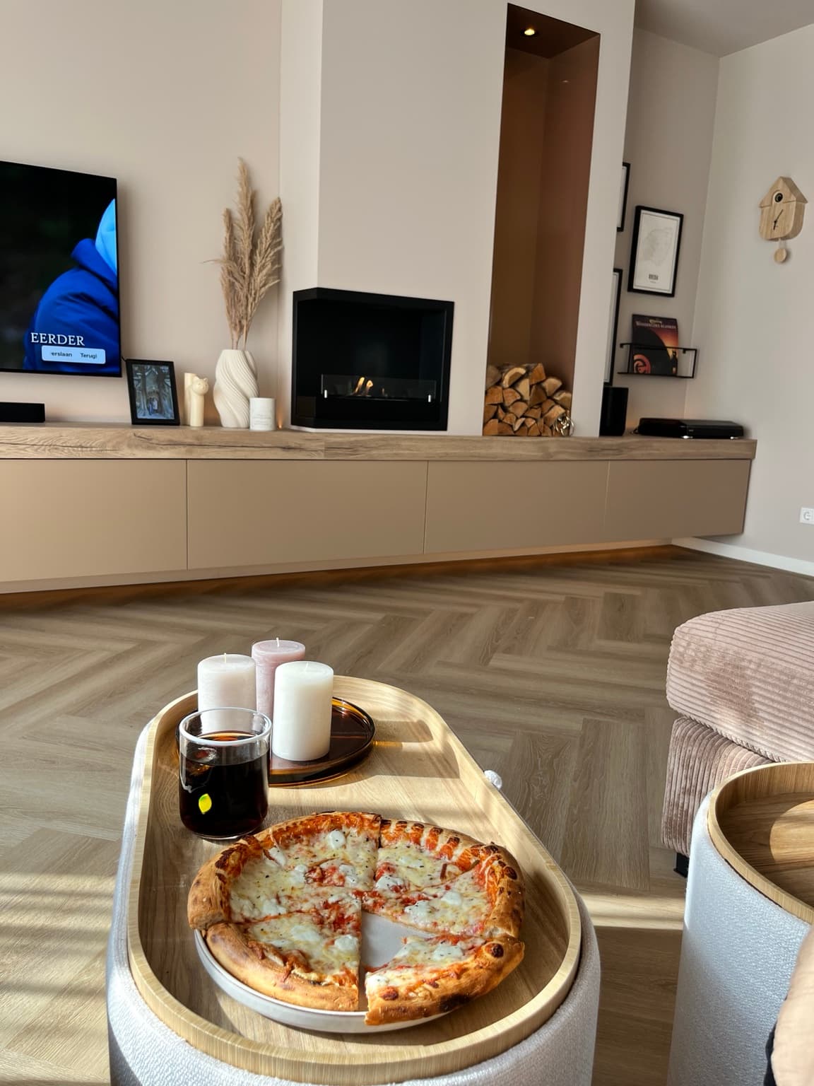 Casual meal in a warm sunlit living room with fireplace and built-in cabinetry.