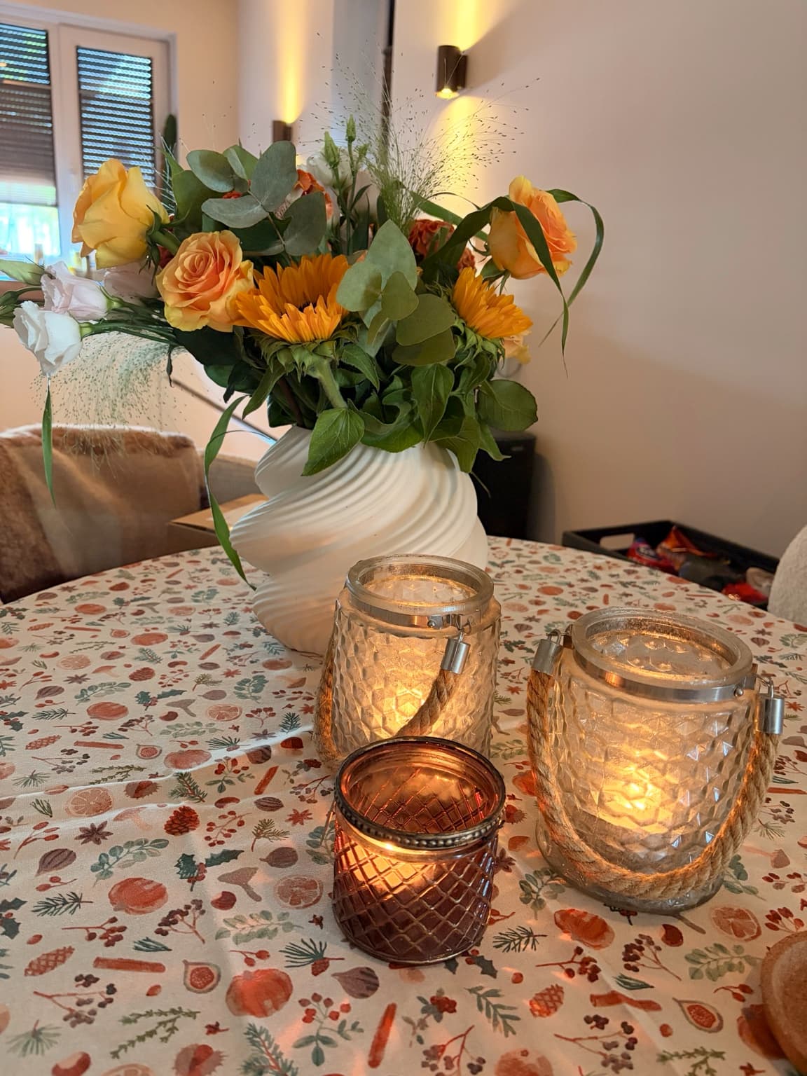 Fresh mixed bouquet arranged in a white vase on Esther's table.