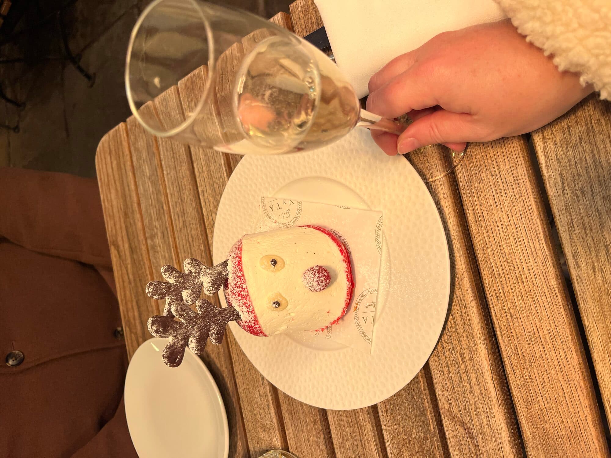 A Santa-shaped dessert with a glass of champagne being poured