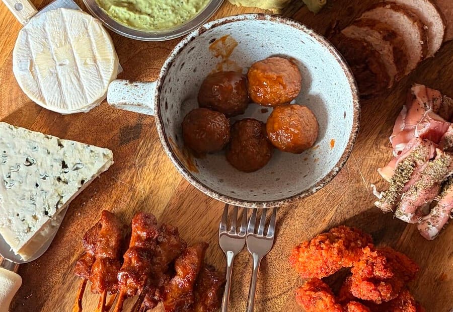 A close view of the picky bits board - sticky meatballs, skewers and crispy chicken.