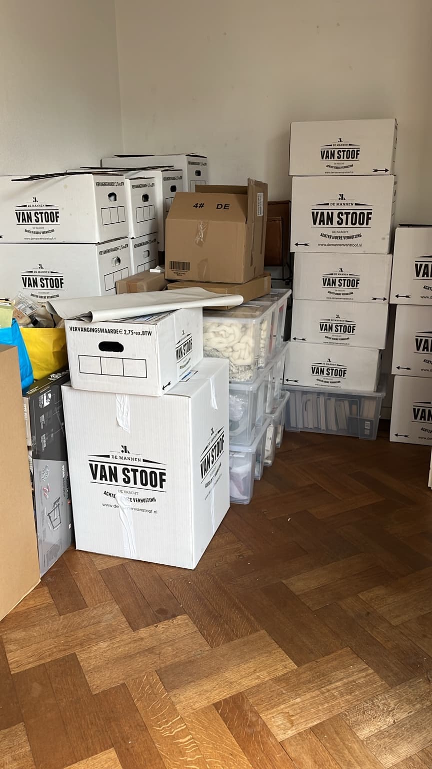 Large group of packed moving boxes in the old home before moving day.