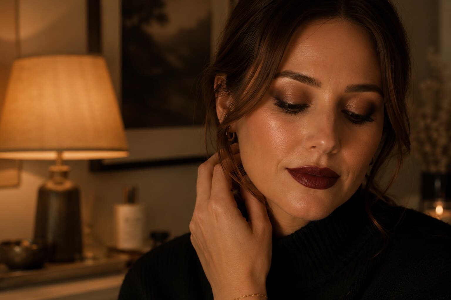 A softly smudged evening eye and a rich lip colour applied in warm lamplight.