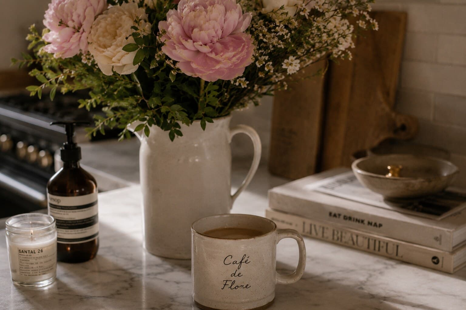 Fresh flowers and a favourite mug on a home kitchen counter, a small habit carried home from travel.