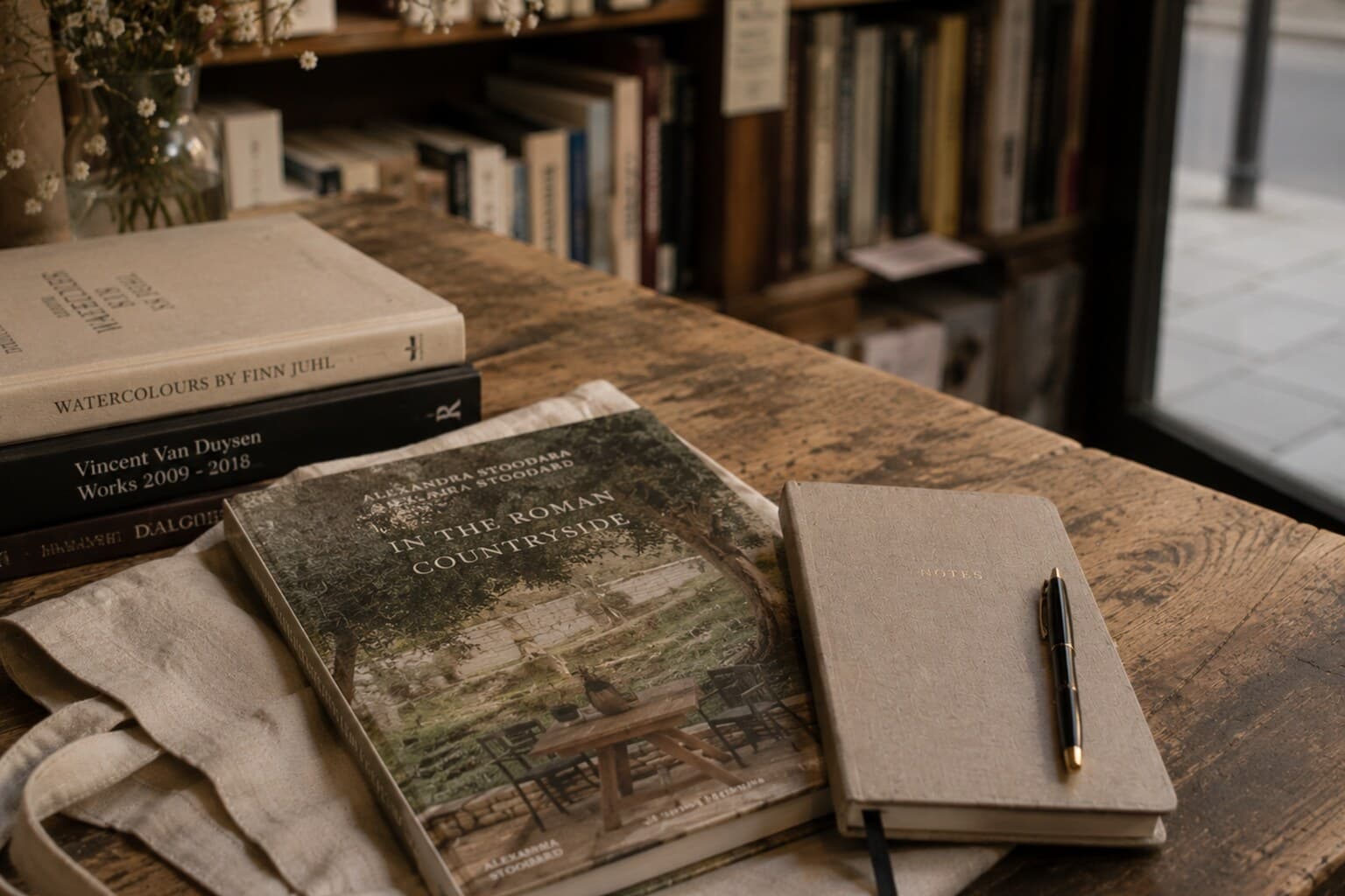 A single book and notebook chosen from a small independent European bookshop.