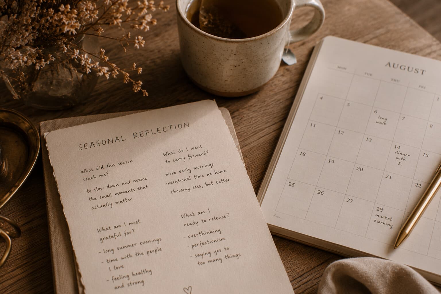 A handwritten seasonal reflection page beside a calendar and a cup of tea.