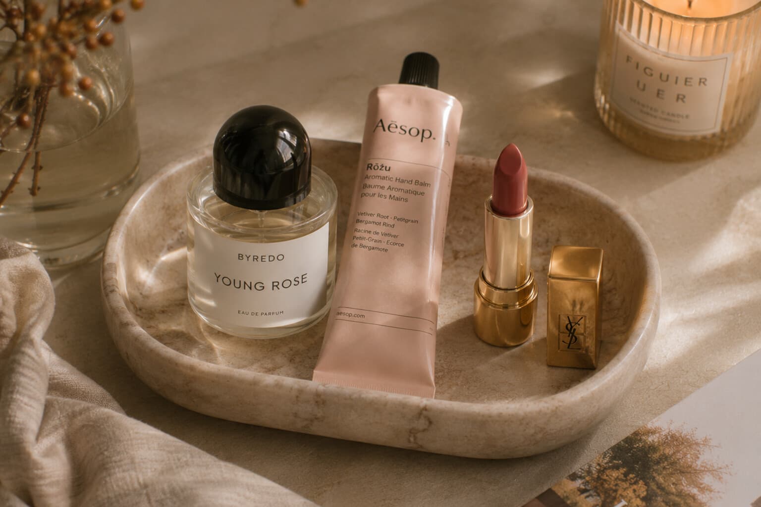 A small seasonal beauty tray with fresh fragrance, hand cream and a new lip colour.
