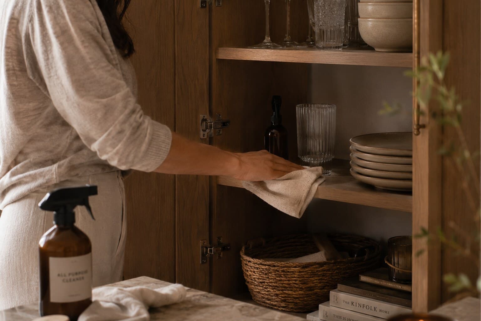 An open cabinet being cleaned during a focused seasonal deep-clean session.