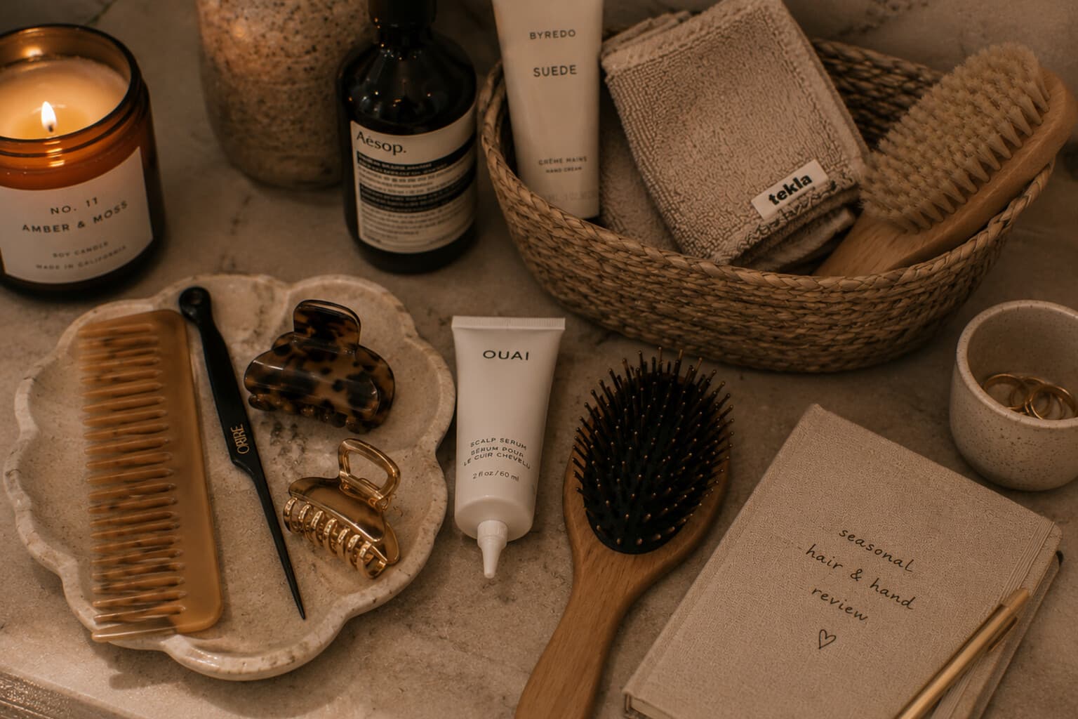 Hair and hand-care tools laid out for a seasonal review beside a small notebook.