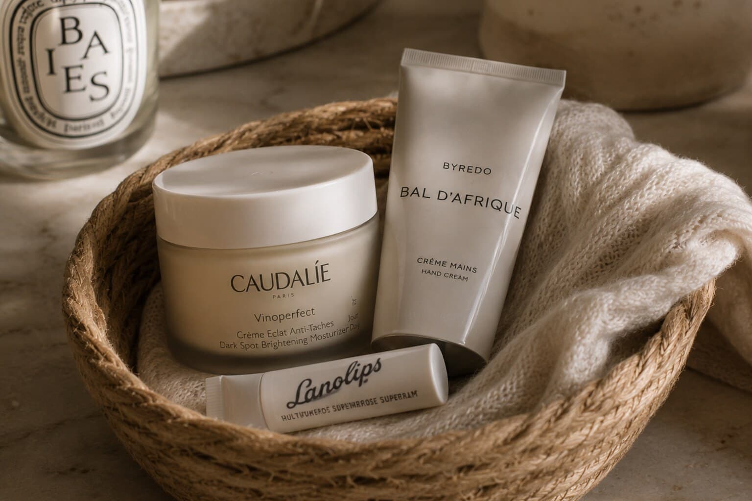 A richer winter moisturiser, hand cream and lip balm arranged in a small basket.