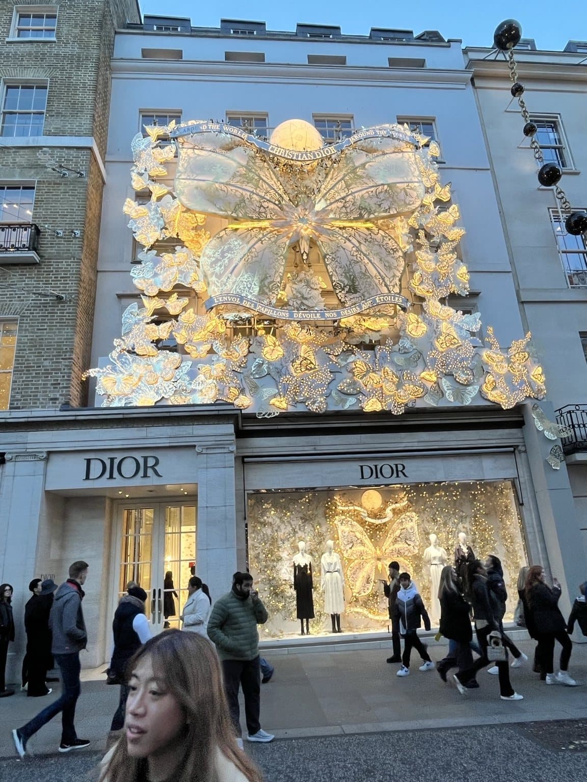 The Dior boutique on Bond Street dressed with an enormous gold and white illuminated bow above the entrance.