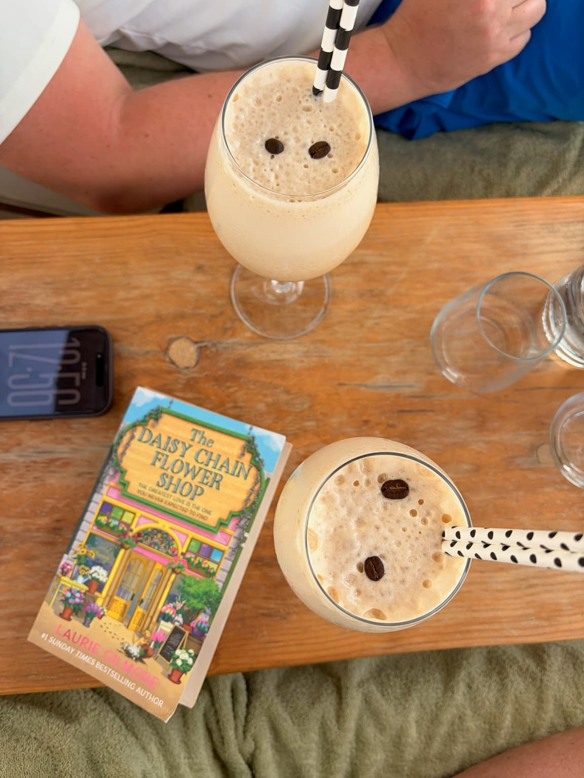 Drinks and a book on a sun lounger at LUUMA Beach