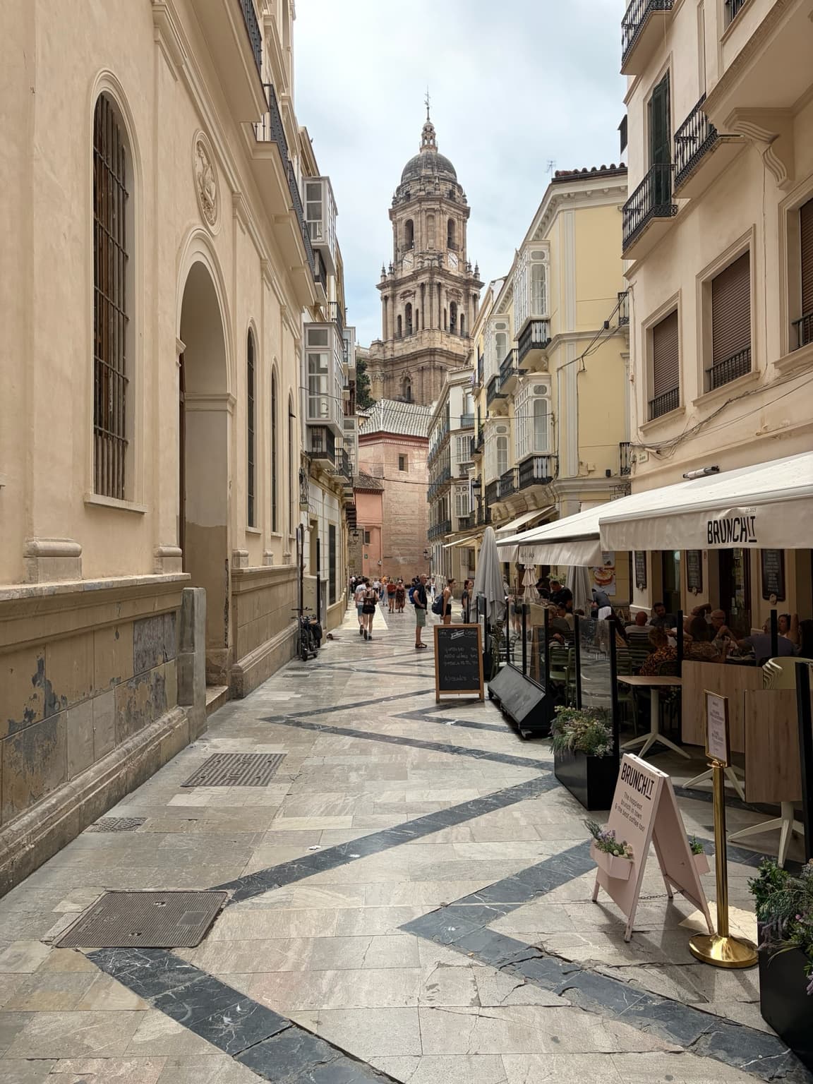 A street in Málaga with a tower visible in the distance