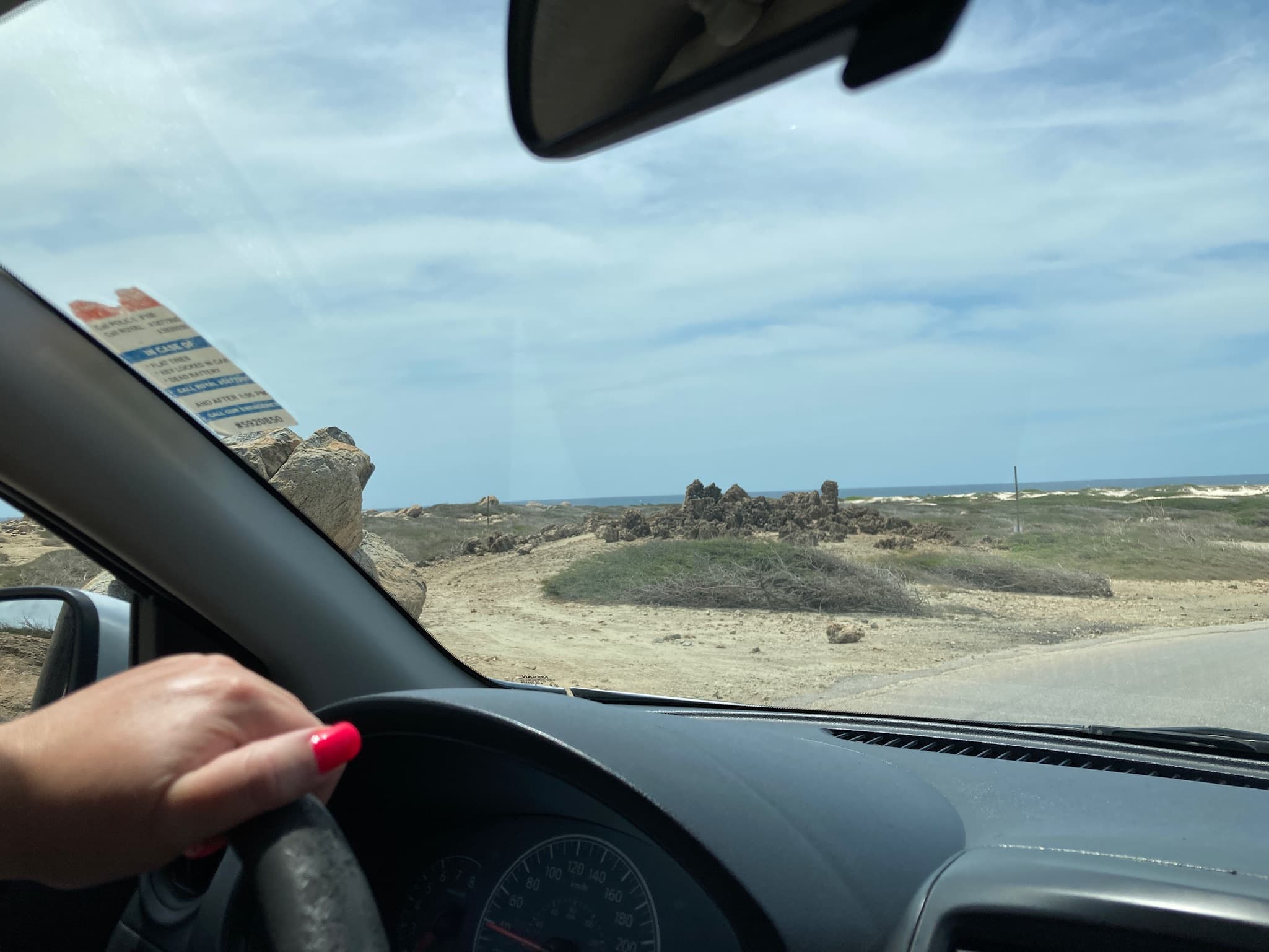 View from the rental car towards Aruba’s rocky, cactus-filled landscape