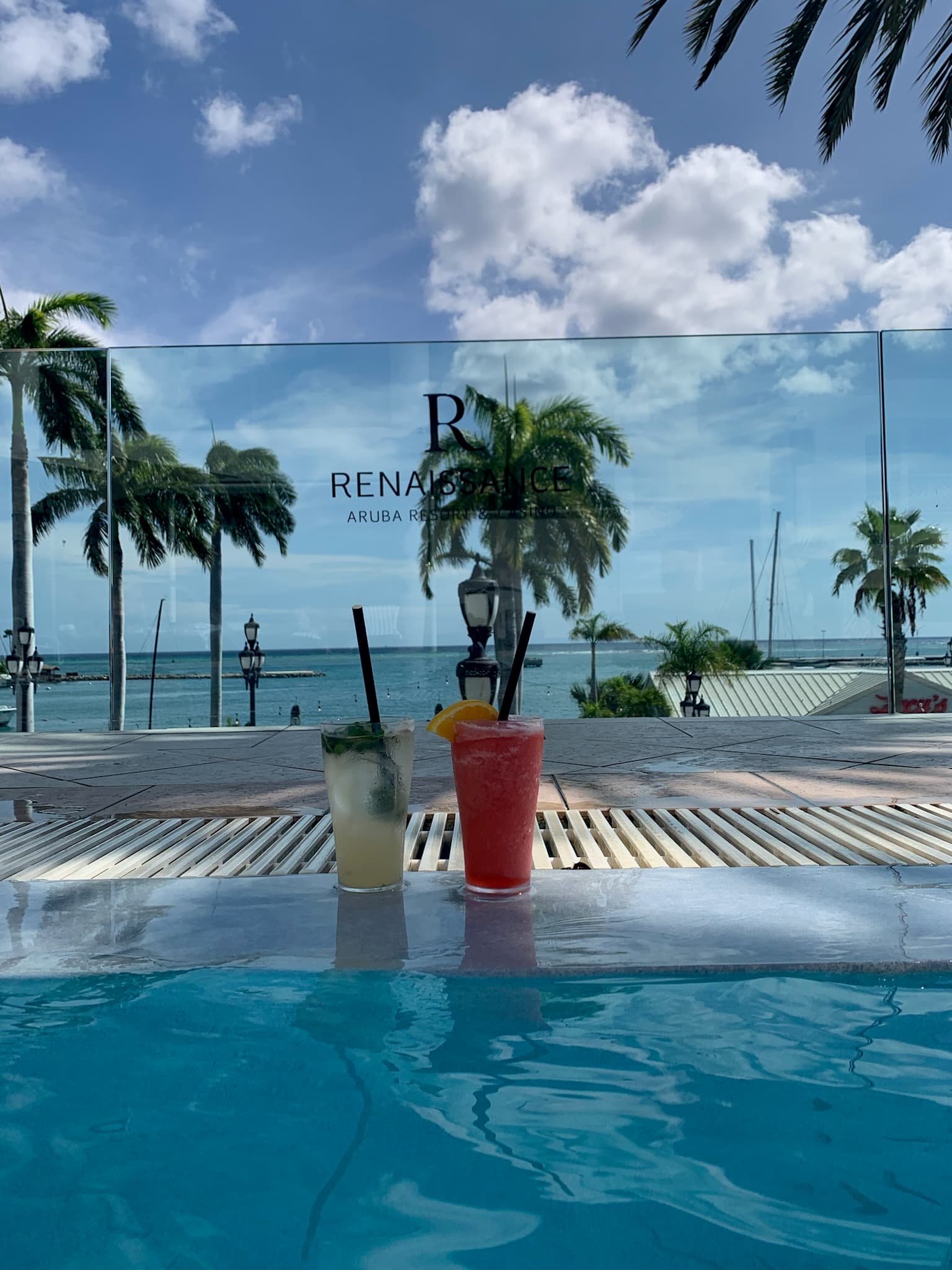 Poolside cocktails overlooking the marina at Renaissance Wind Creek Aruba Resort