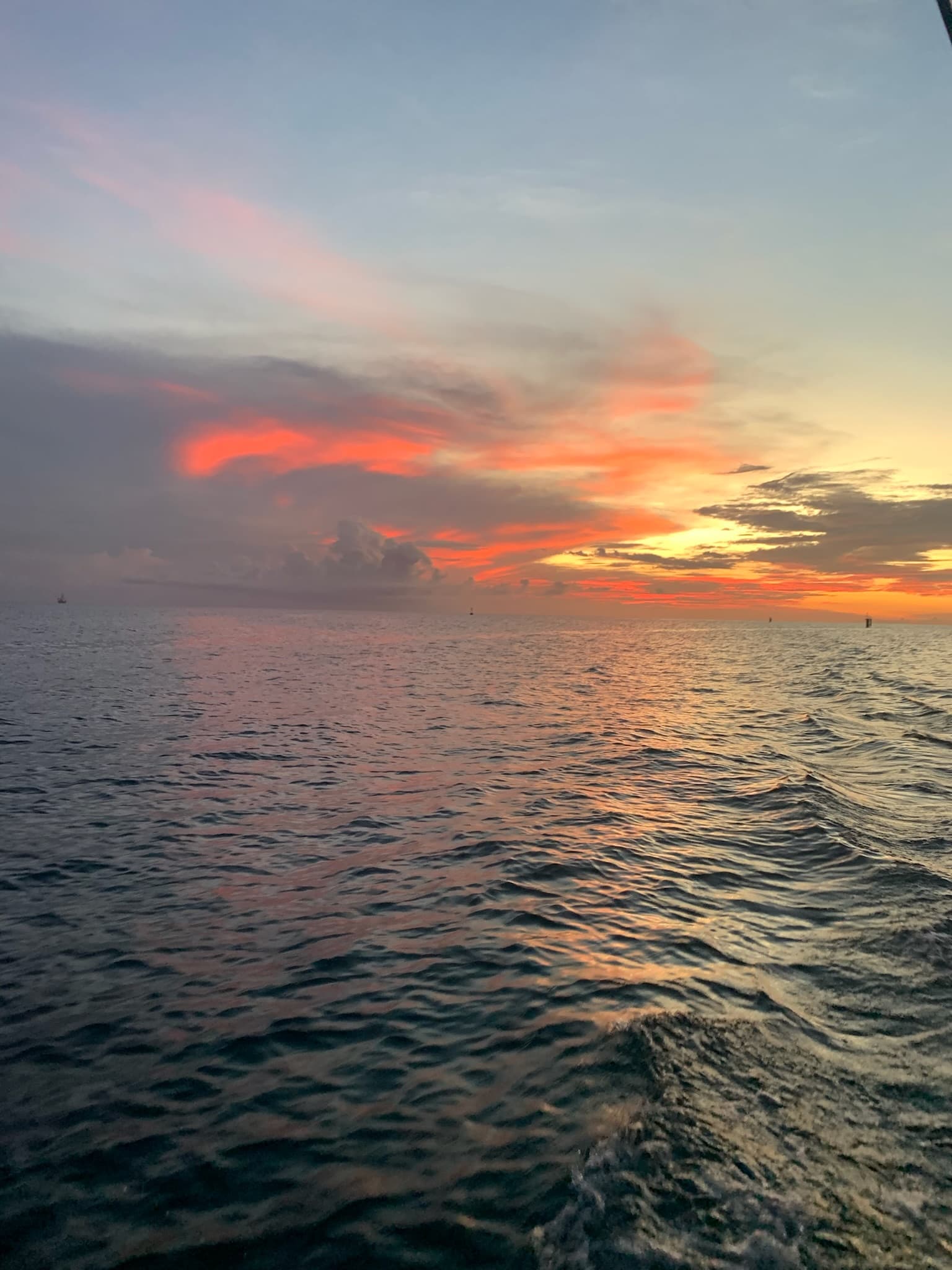 Coral and gold sunset seen from a boat off the coast of Aruba