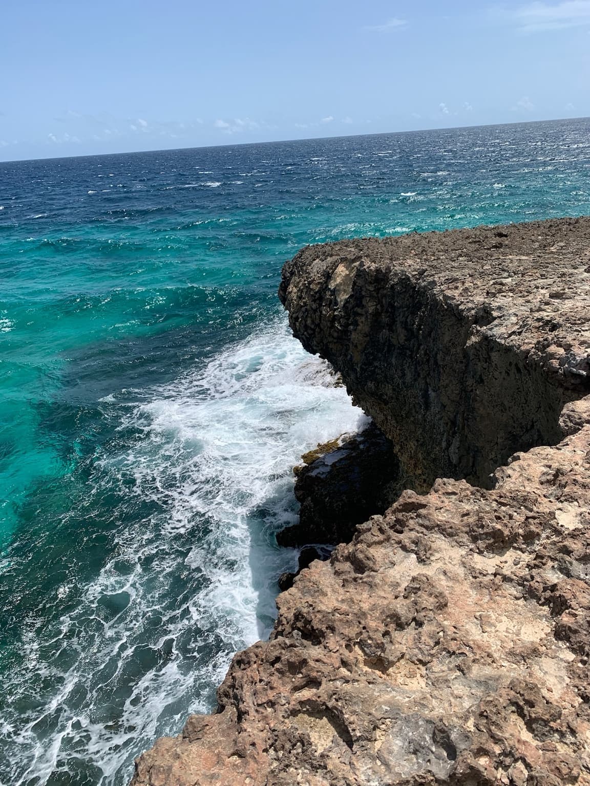 Waves crashing against Aruba’s rugged limestone north coast