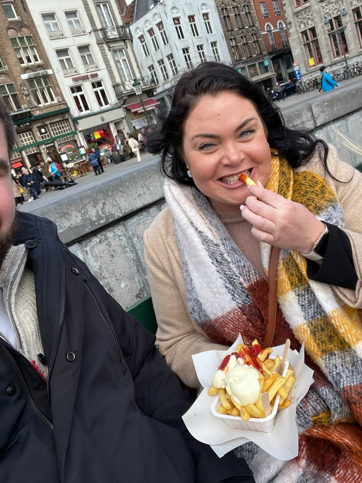 Esther enjoying Belgian fries beside a canal in Bruges