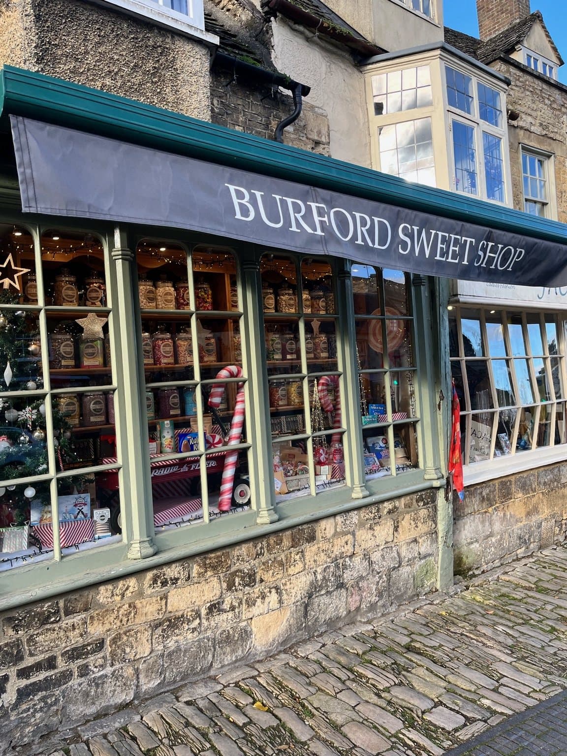 Burford Sweet Shop window with jars of sweets and Christmas decorations