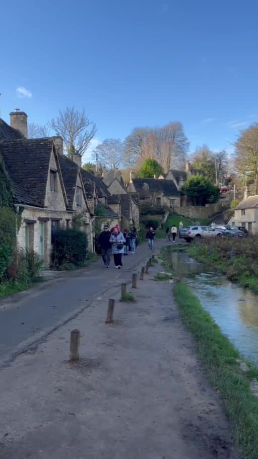 Arlington Row in Bibury: a lane of old stone cottages with steep roofs beside the water