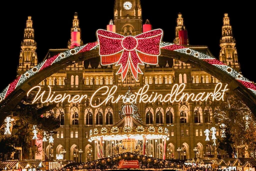 The Wiener Christkindlmarkt entrance at Rathausplatz in Vienna, lit up at night
