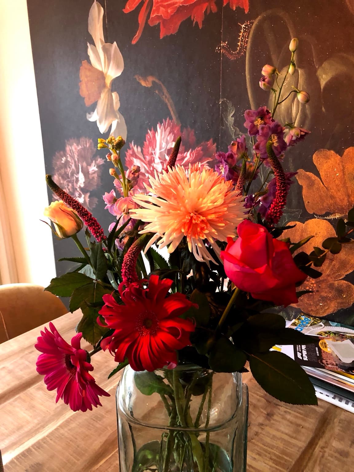 Esther’s photograph of pink, red and peach flowers in a glass vase.
